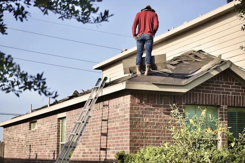 Professional roofer working on a residential roof in Helen Marie Court